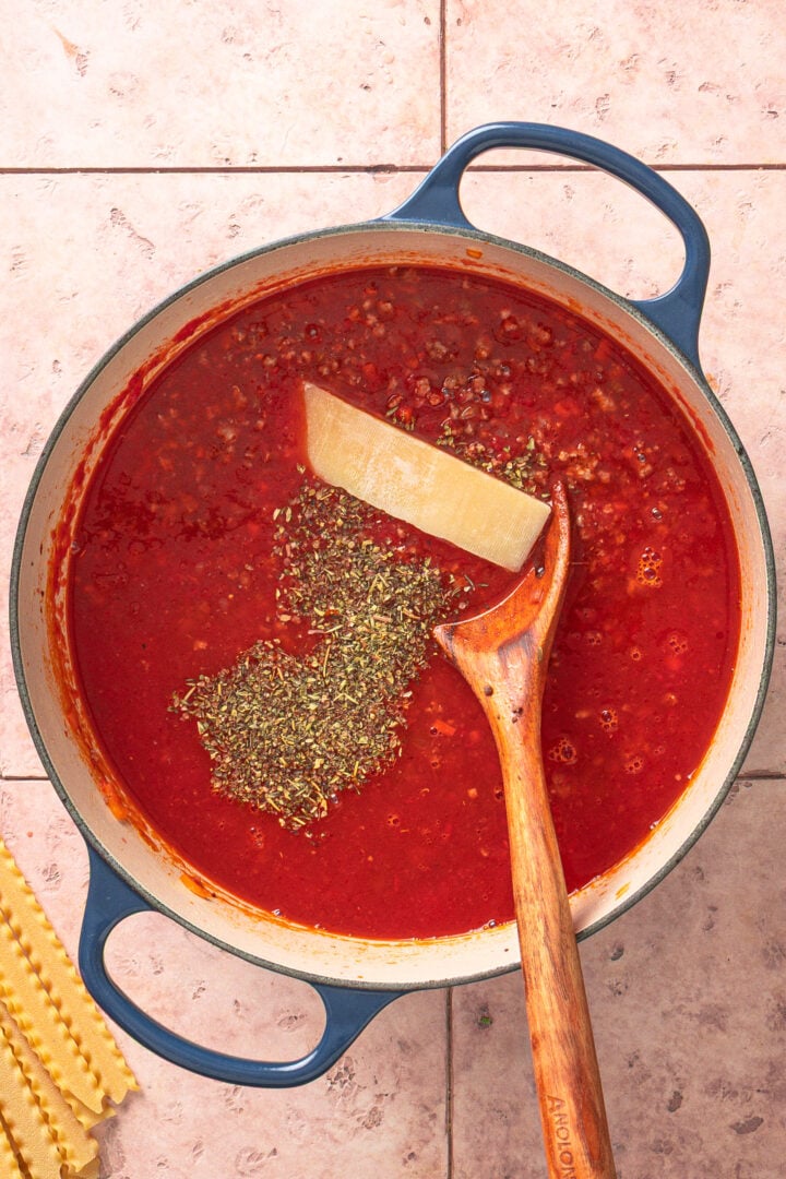 Crushed tomatoe, broth, parmesan rind and italian seasoning added to pot with meat and vegetables