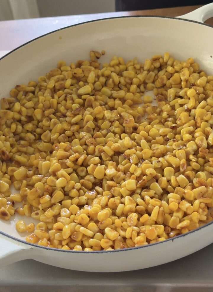 Corn kernels lightly charred in a skillet for Mexican street corn dip
