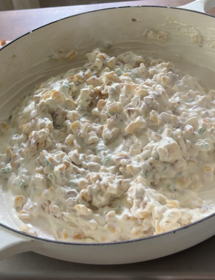 Creamy corn mixture with mayo and crema for Mexican street corn dip before seasoning