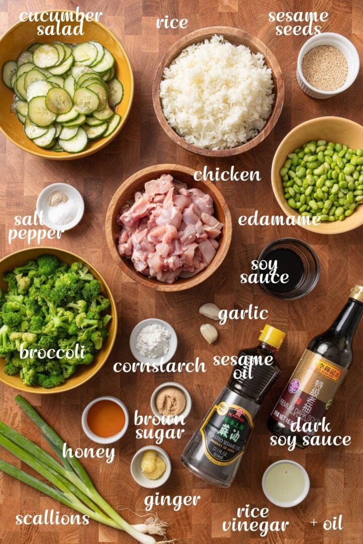 Chicken teriyaki rice bowl ingredients including rice, broccoli, cucumber salad, and teriyaki chicken.