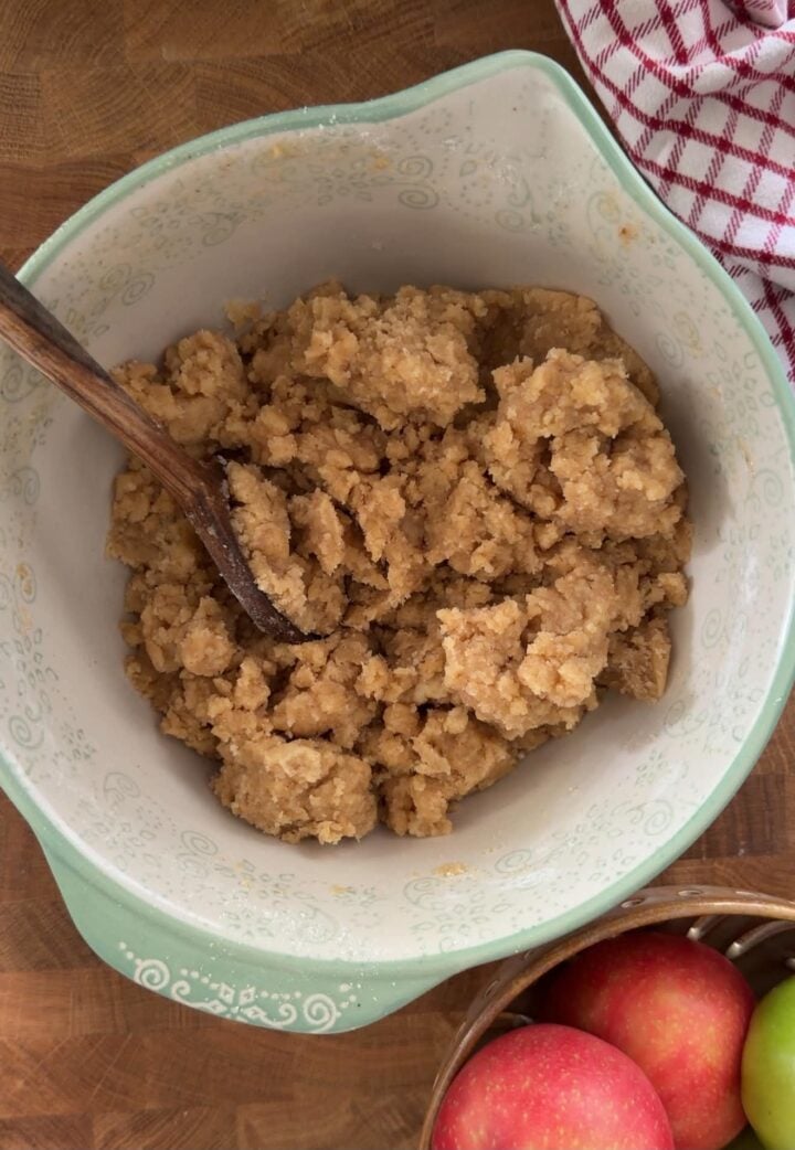 Brown butter crumble dough mixed in a bowl for homemade apple crumble bars.
