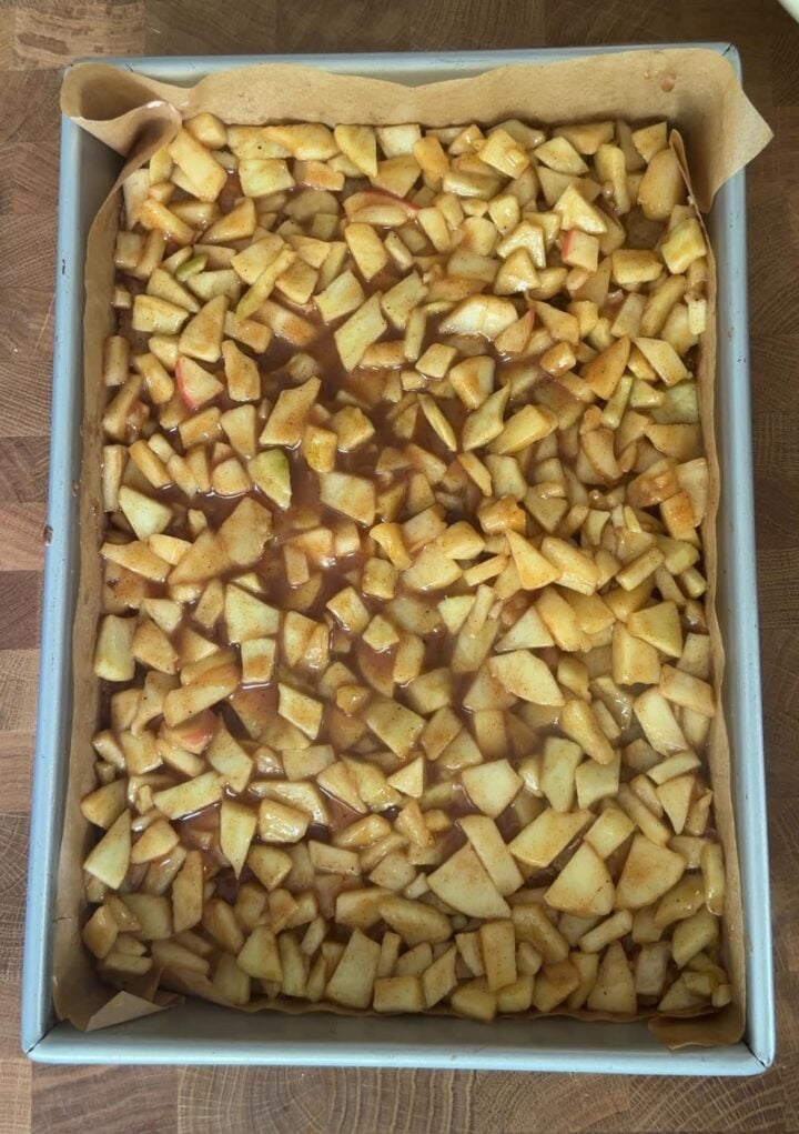 Cinnamon apple filling spread evenly over the par-baked brown butter crust.